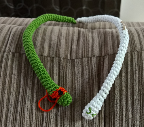 Crocheted Snakes hanging out on the back of the couch